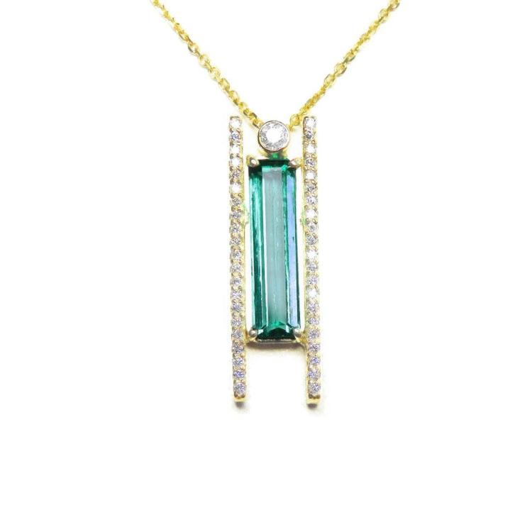 14k yellow gold necklace with a green baguette cut emerald gemstone pendant on a white background