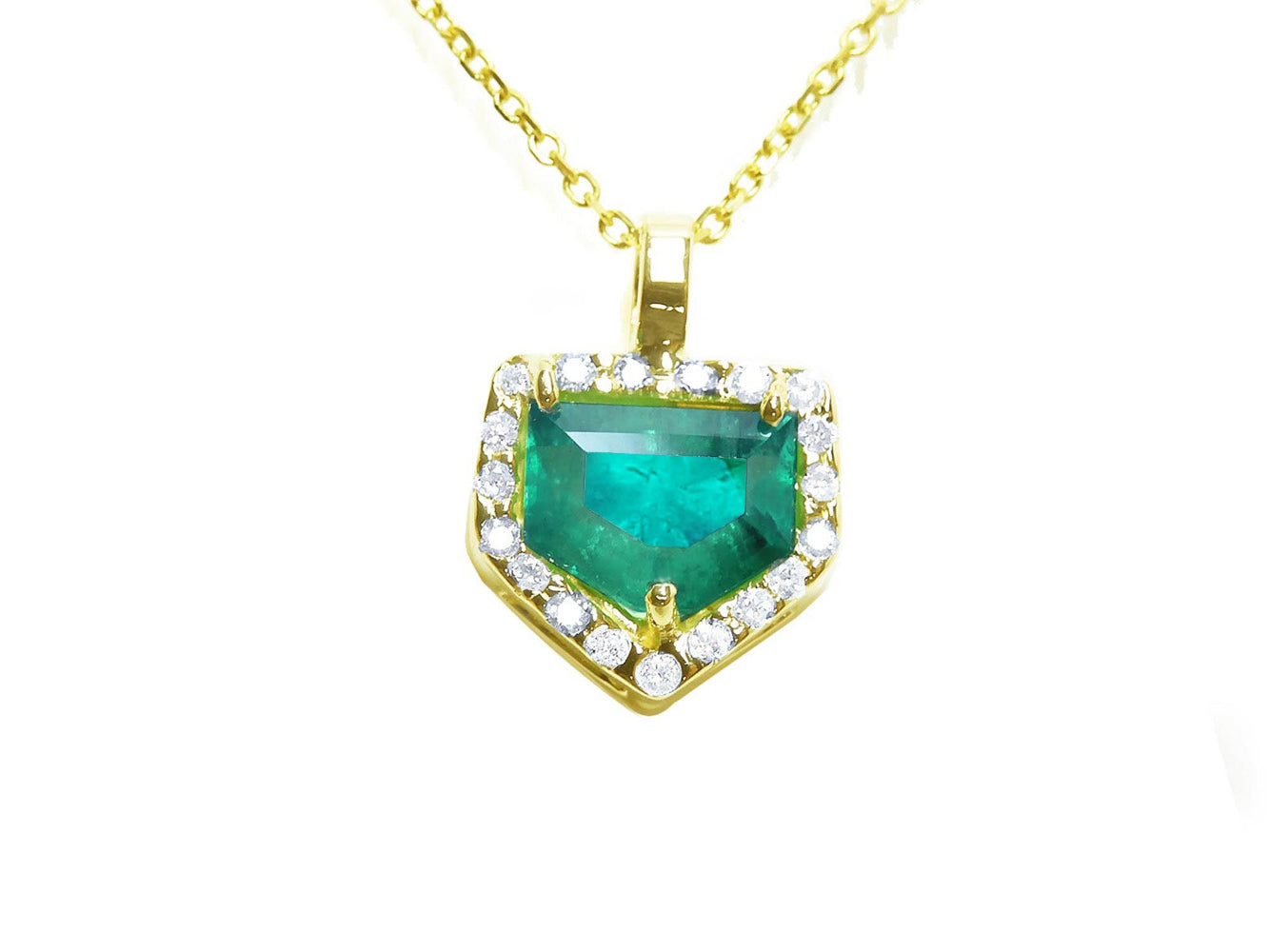 Gold necklace with a heart-shaped emerald pendant on a topside view position.