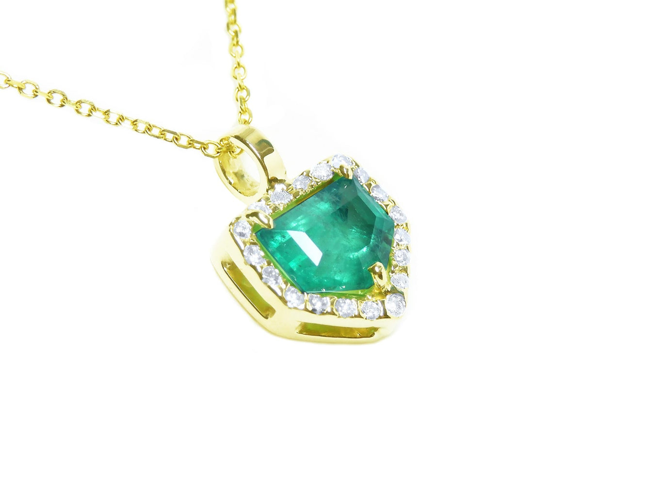 Gold necklace with a genuine colombian emerald pendant on a topside and gallery view.
