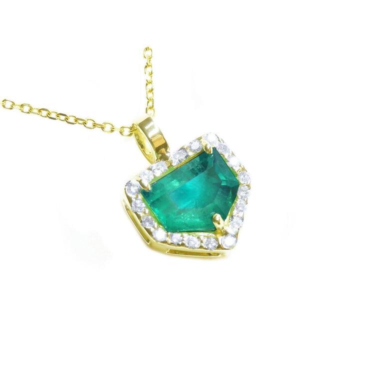 Yellow gold pendant with a natural emerald and diamond accents on a toside view.