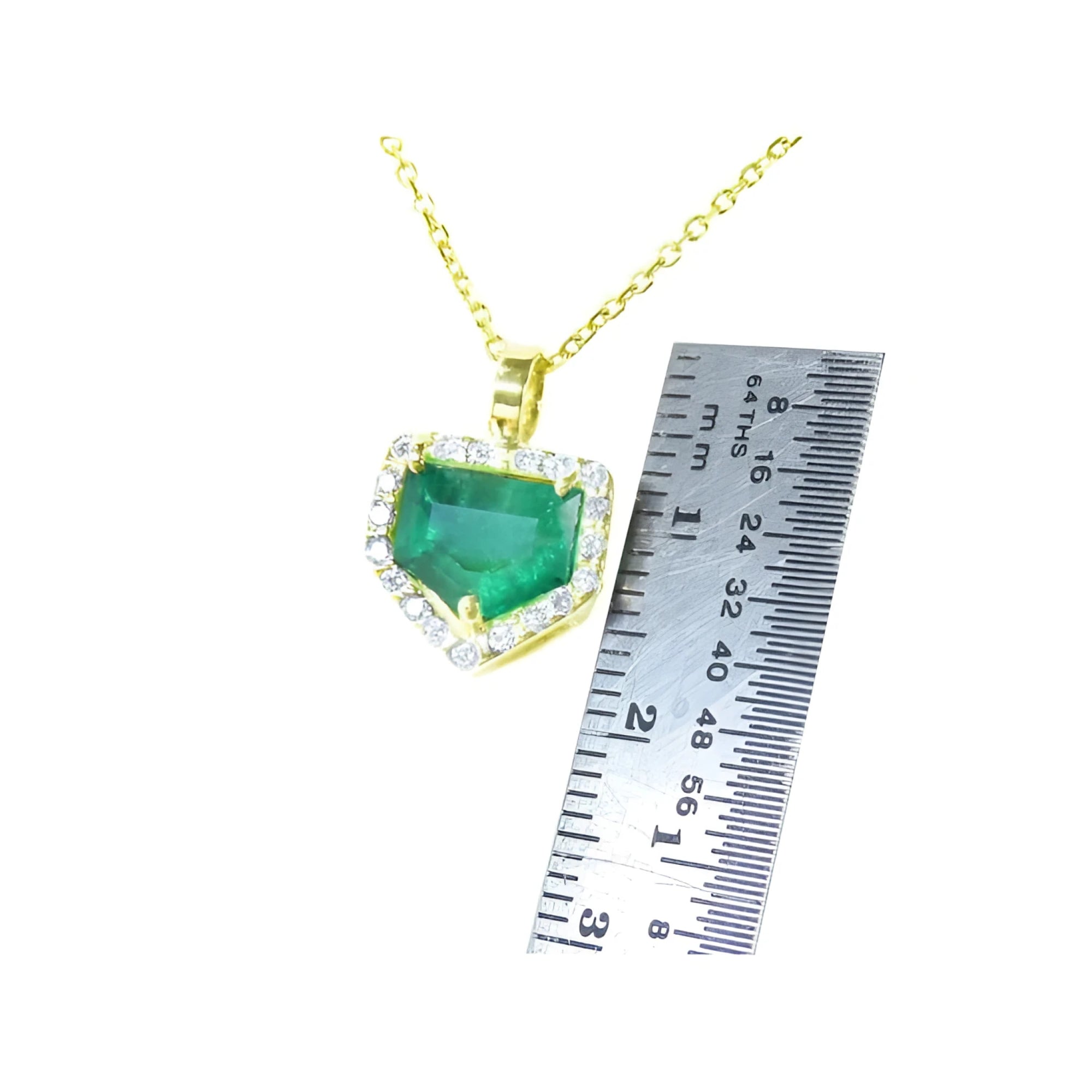 1.75 ct. Colombian emerald pendant with diamond halo on a 14K gold chain, shown with a ruler for scale.