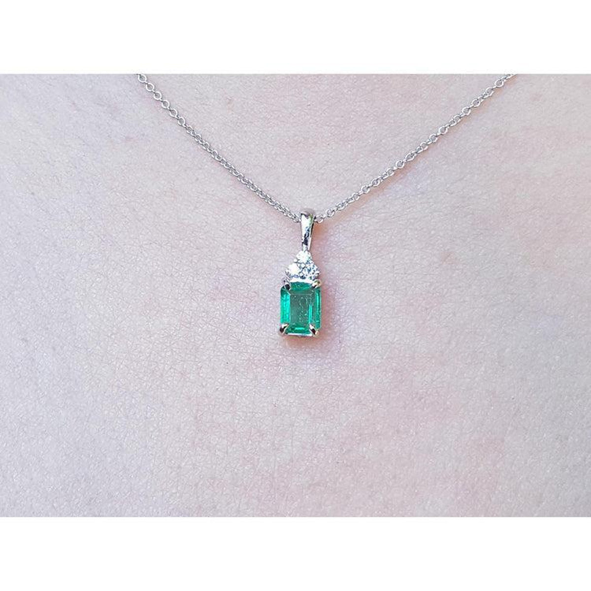 0.27 ct emerald pendant necklace with a vibrant green emerald and diamonds in 14K white gold.