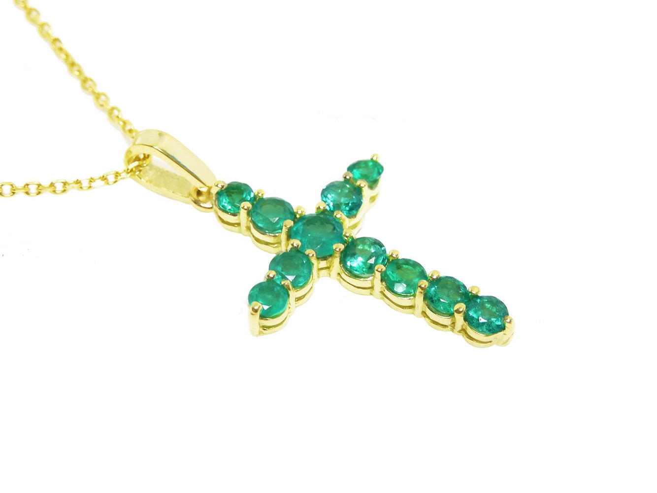 A 18k yellow gold emerald cross pendant necklace displaying a topside view and gallery profile.
