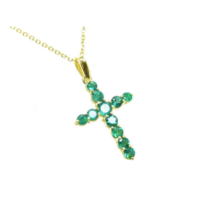 A 18k yellow gold emerald cross pendant necklace on topside position view.