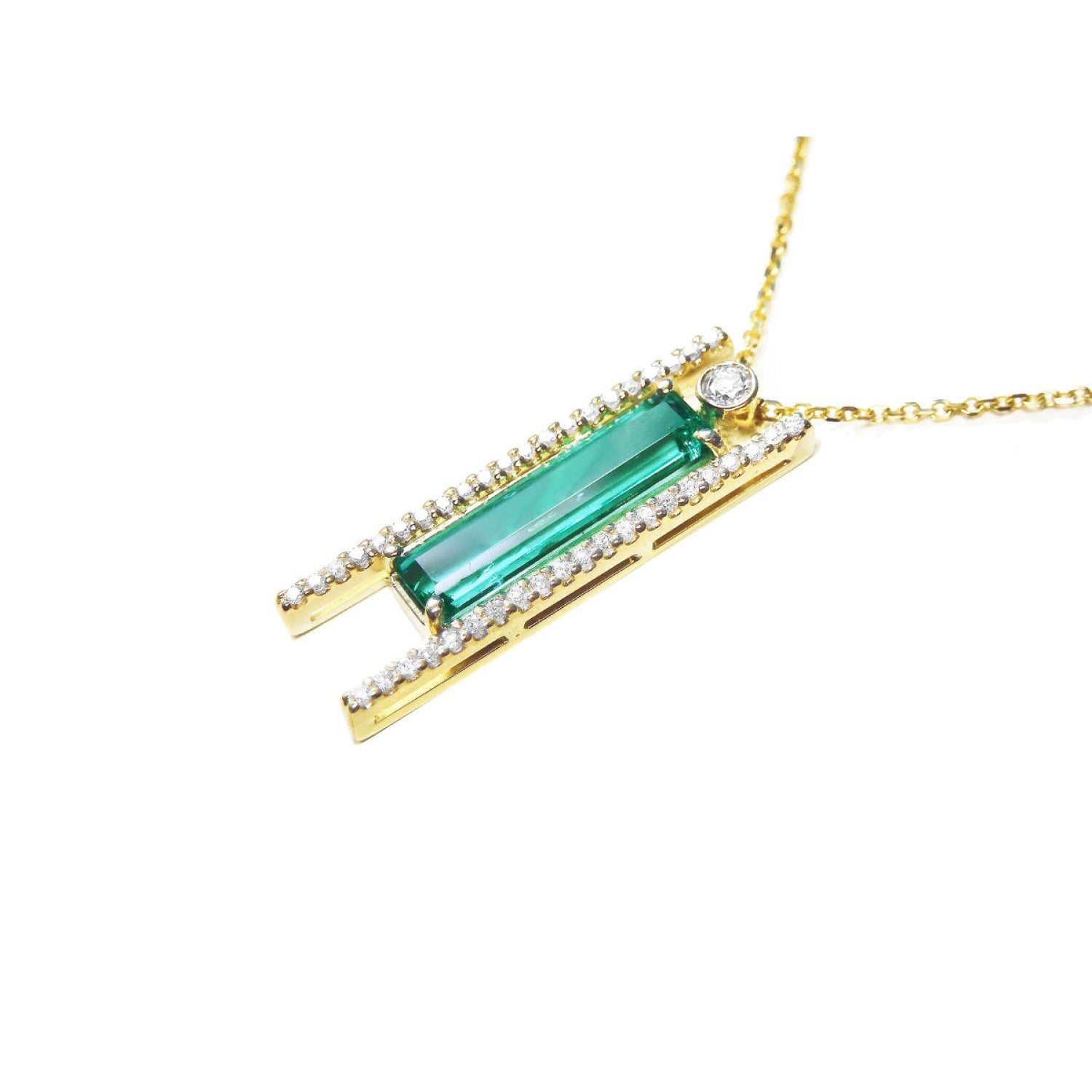 14K yellow gold necklace with a baguette-cut emerald, surrounded by natural diamonds, on a delicate chain.