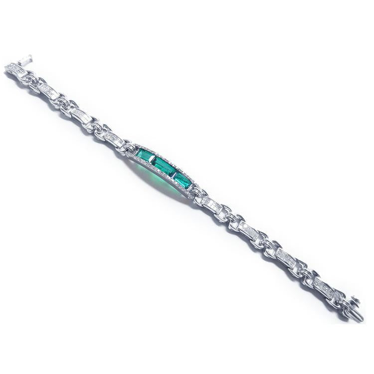 White gold bracelet with vibrant Colombian emeralds and princess-cut diamonds.