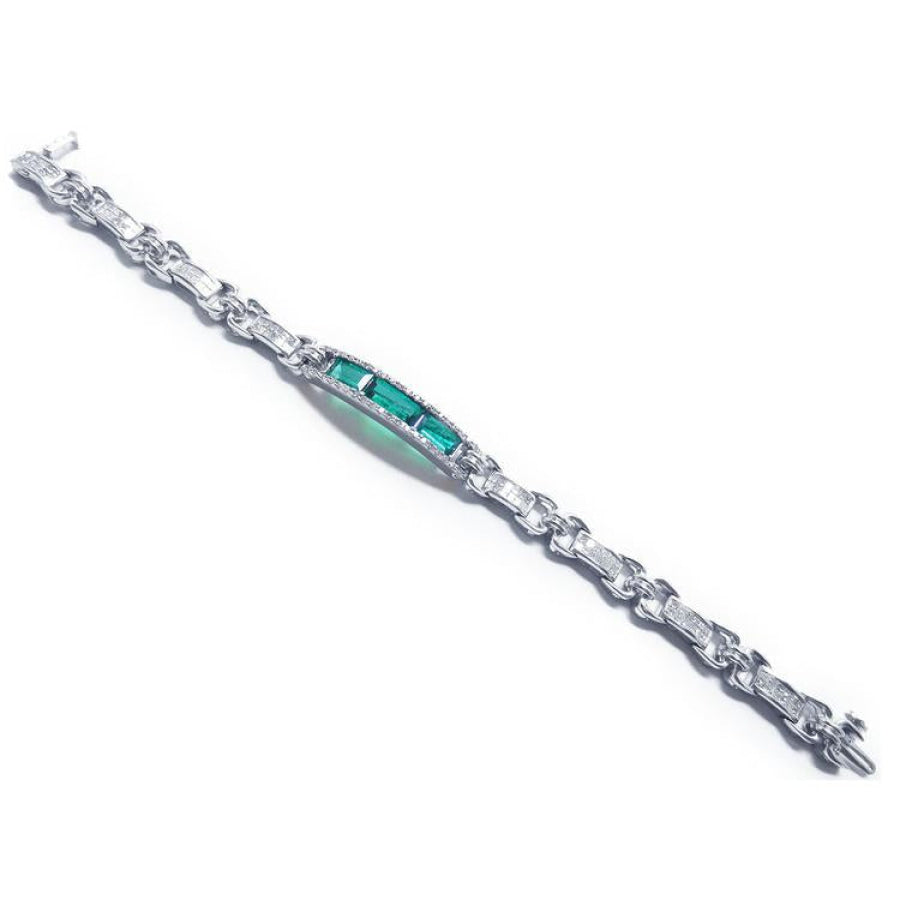 White gold bracelet with vibrant Colombian emeralds and princess-cut diamonds.