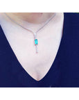 Women's 14K white gold necklace with an elongated Colombian emerald and diamond accents.
