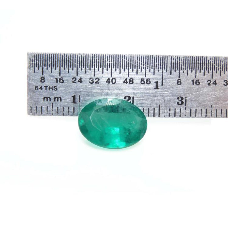 3.68 ct GIA certified loose oval emerald, bright bluish-green, displayed with a ruler for scale.