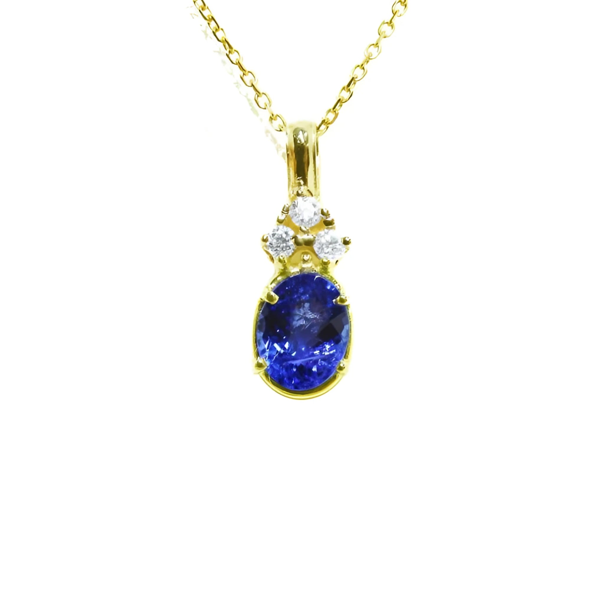 14K yellow gold pendant with an oval tanzanite and three round diamonds on a delicate chain.