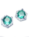 Diagonal top view position of pair of hexagonal halo diamond emerald stud earrings white gold.