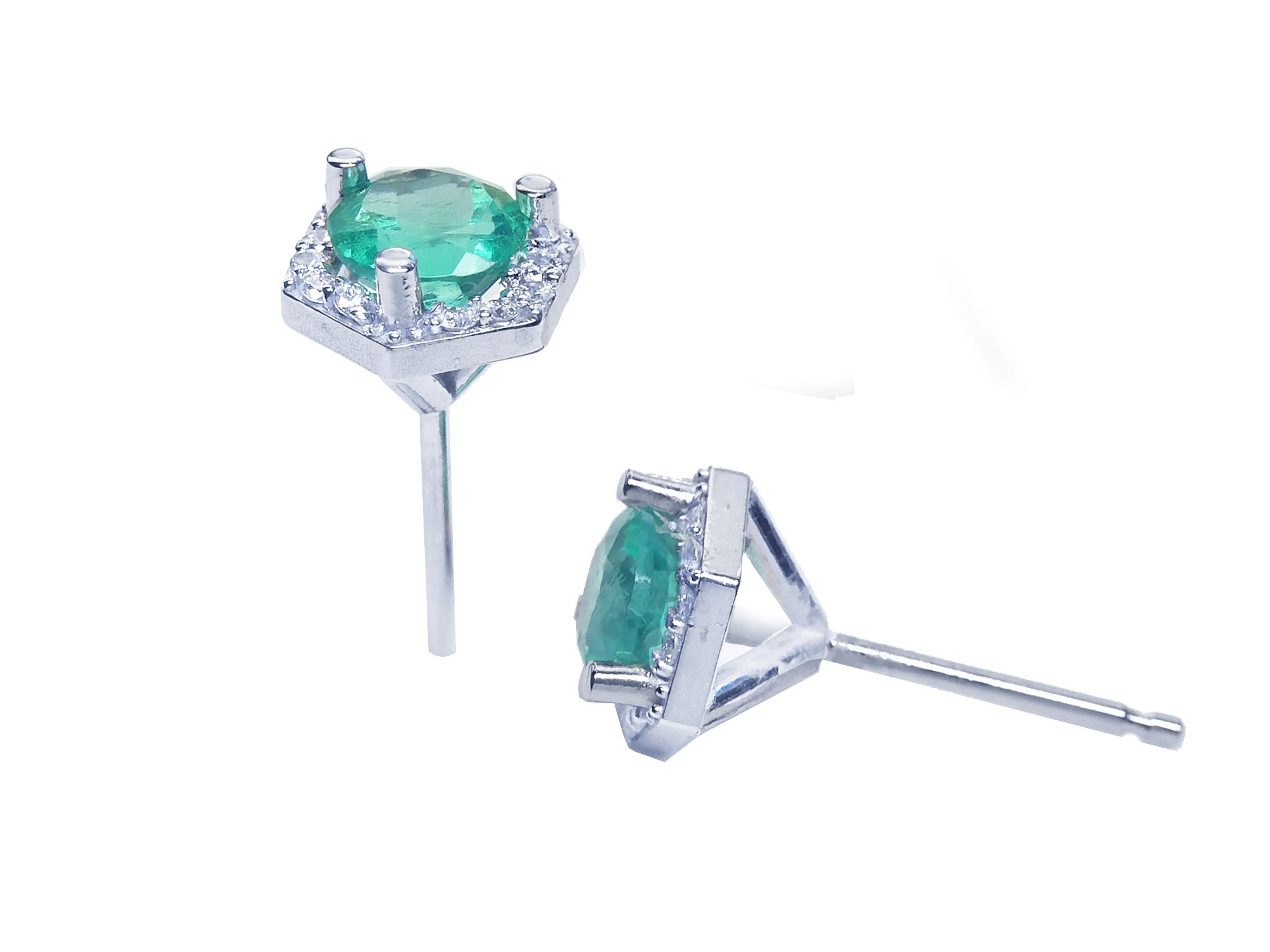 A pair of emerald stud earrings hexagonal halo diamonds, underside profile view.