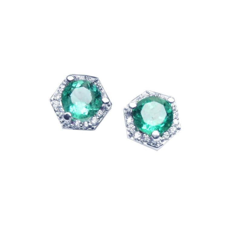 A pair of round cut Colombian emerald stud earrings with hexagonal halo of natural diamonds, set in 14K white gold.