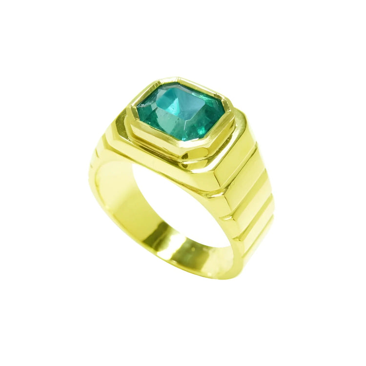 A 18k yellow gold men's ring with a GIA certified F1 natural colombian emerald bezel set.