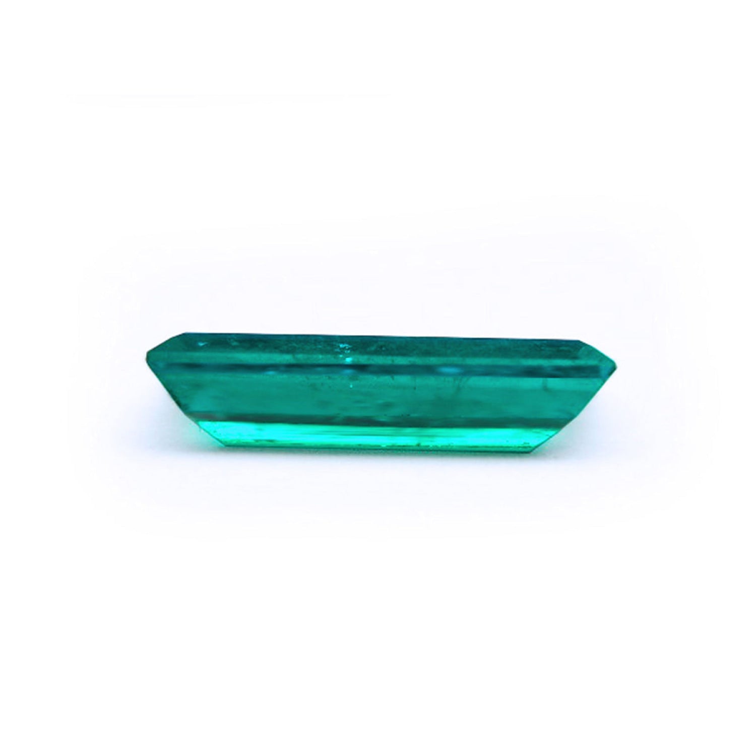 3.13 carat baguette cut Colombian emerald, sparkling bluish-green, eye-clean.