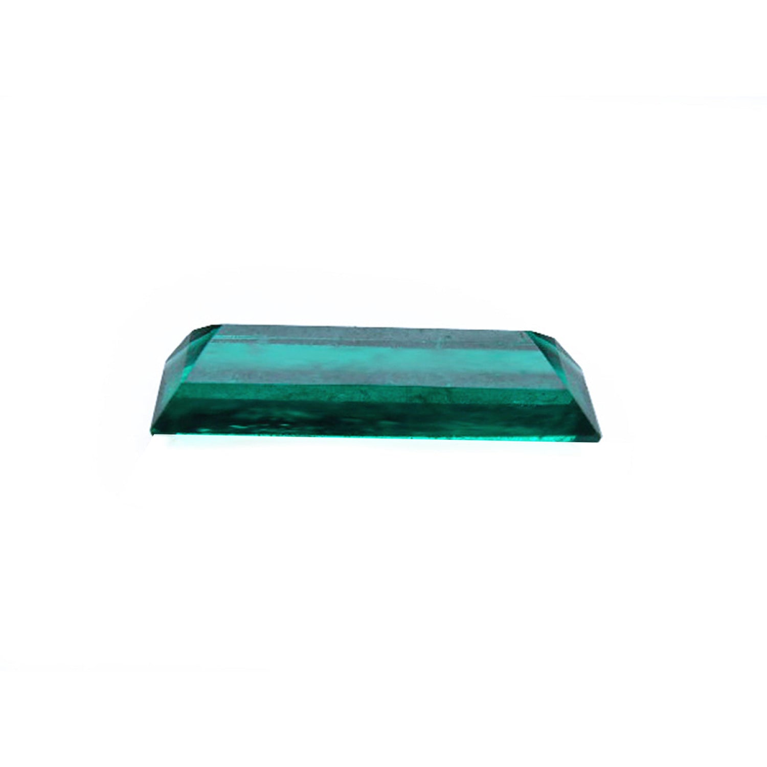 3.13 carat baguette cut Colombian emerald with sparkling bluish-green color.