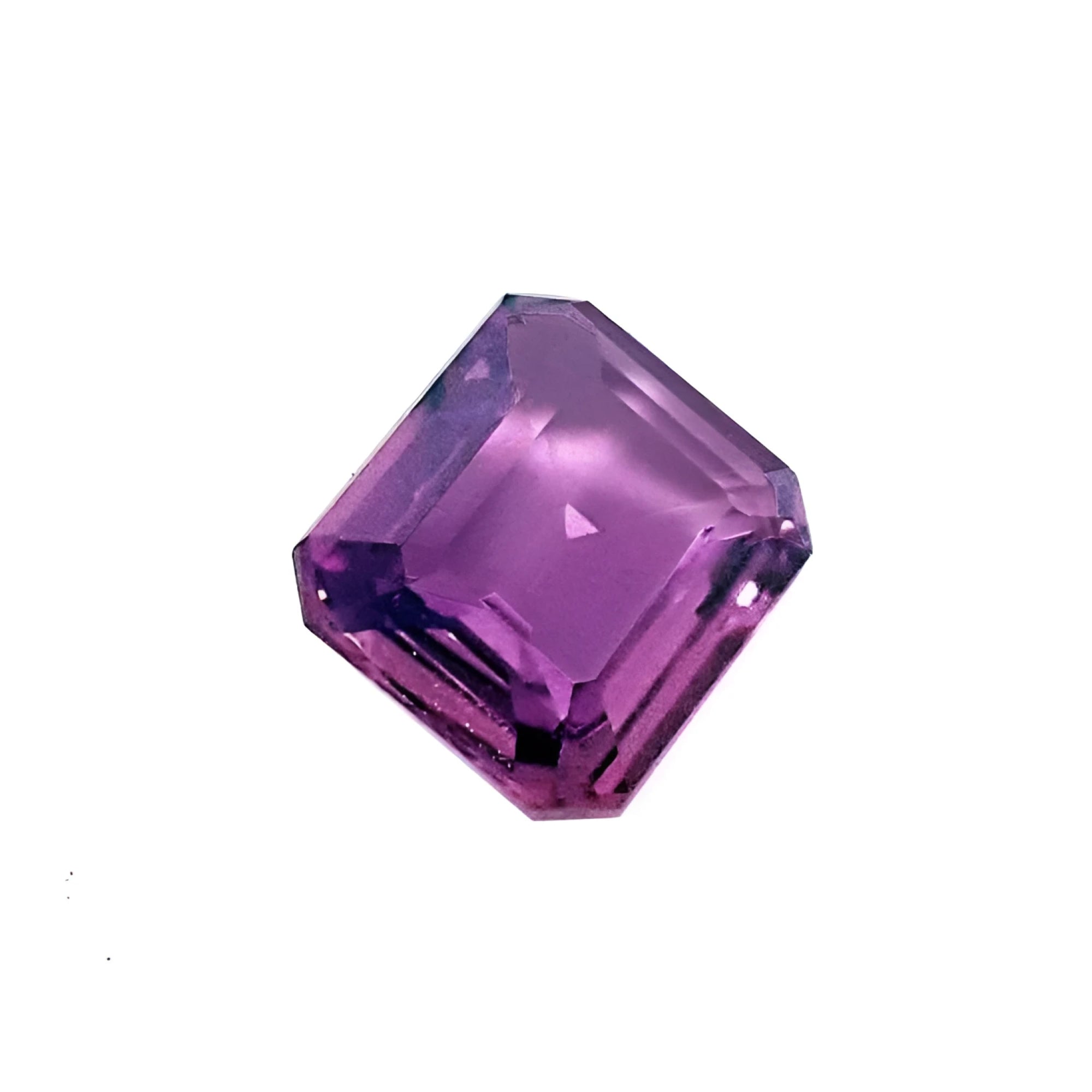 4.05 ct natural loose pink sapphire with an emerald cut, displaying vibrant purple hues.