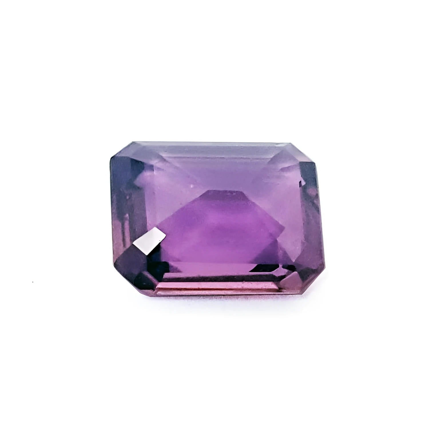 4.05 ct natural loose pink sapphire with an emerald cut, displaying a clear purple hue.