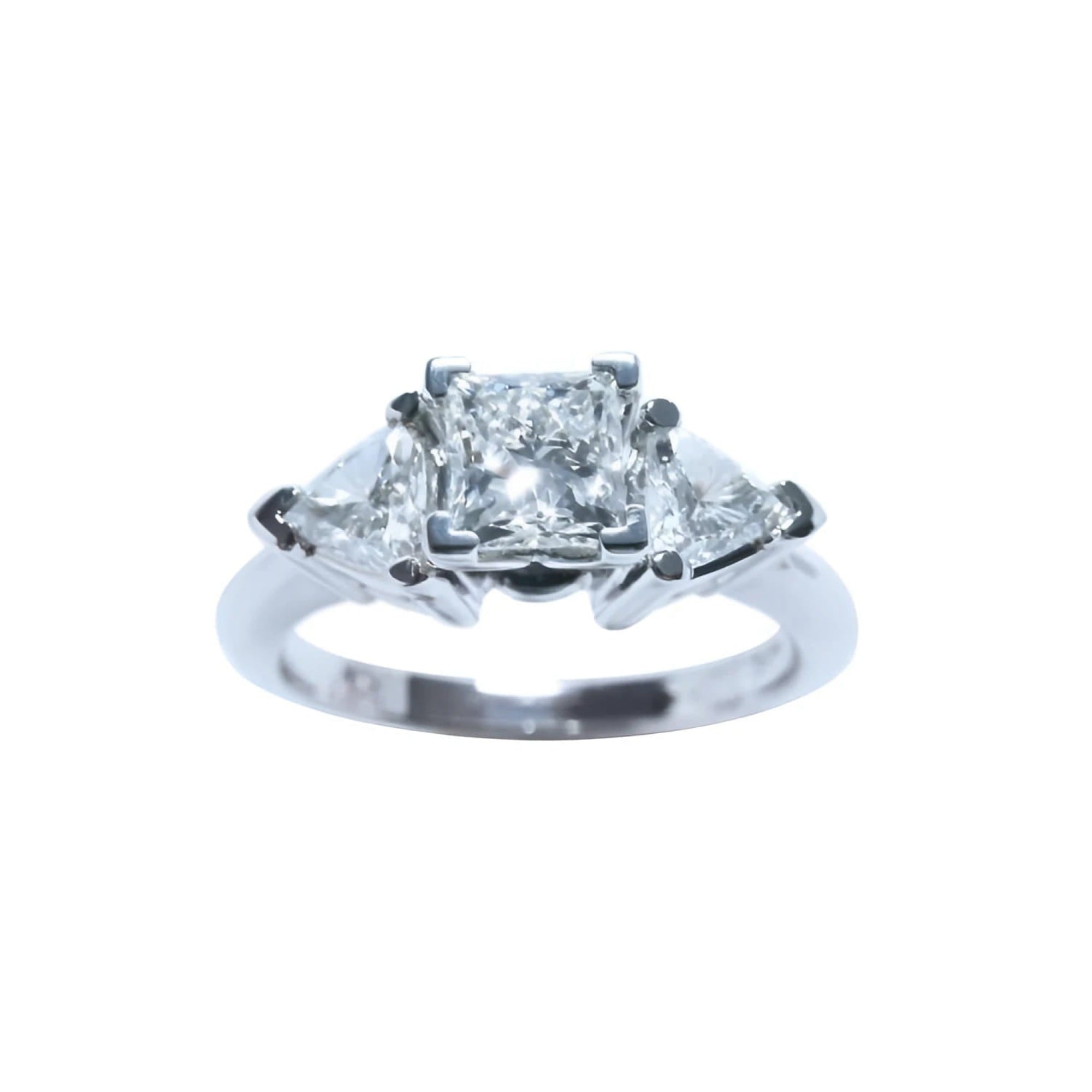 This GIA-certified radiant cut diamond ring features a 0.77 ct center stone and 0.47 ct trillion-cut side stones, for a total weight of 1.24 ct. 