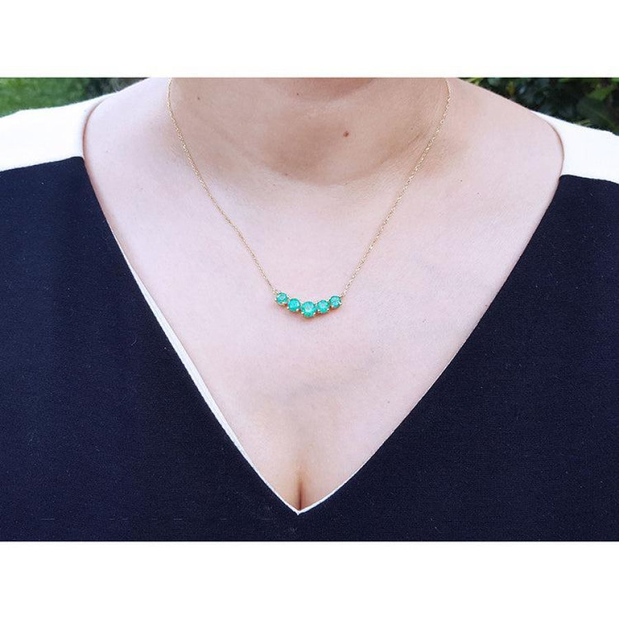 14K gold necklace with five round medium green Colombian emeralds in elegant basket settings.