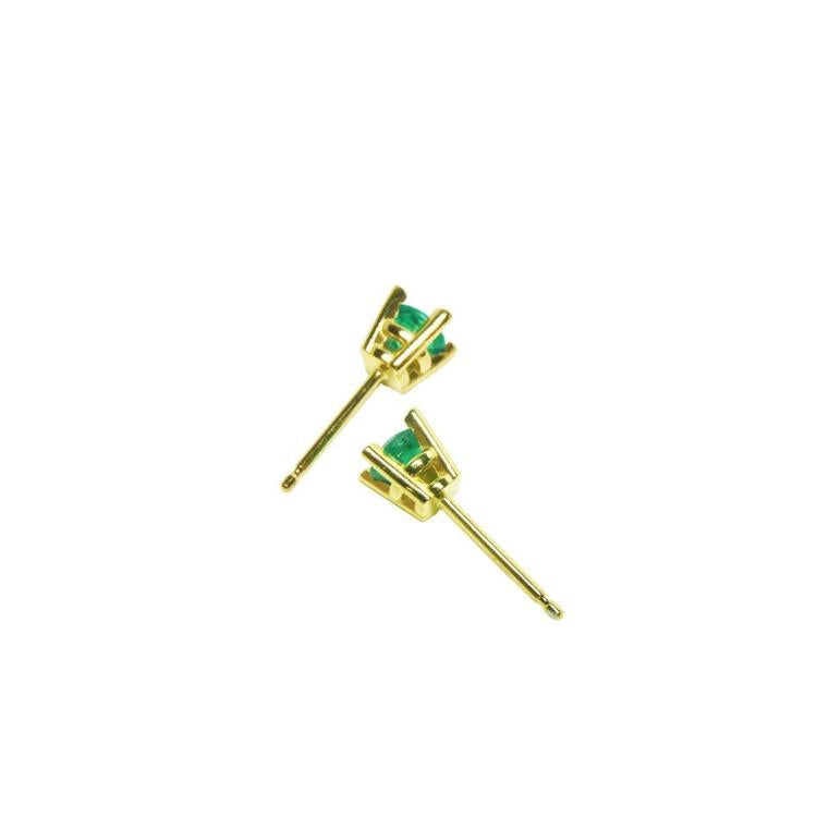 Girls' 14K gold stud earrings with round natural Colombian emeralds.