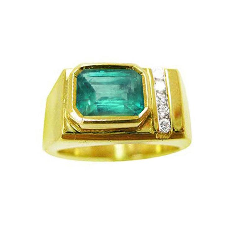 A yellow gold ring with a natural emerald bezel set and small diamonds on a topside view.