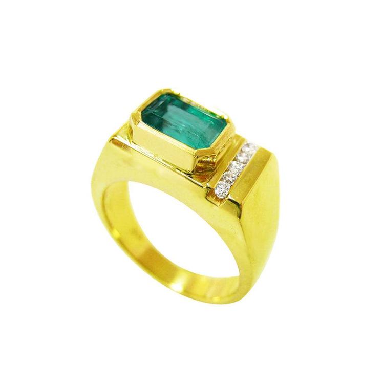 Men's 14K yellow gold ring with an east-west emerald-cut Colombian emerald and channel-set diamonds.