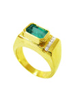 A gold ring for man with a natural emerald and diamond accents on a white background