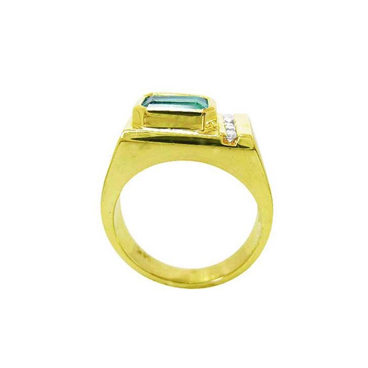 Men's 14K yellow gold ring with an east-west emerald-cut Colombian emerald and channel-set accent diamonds.