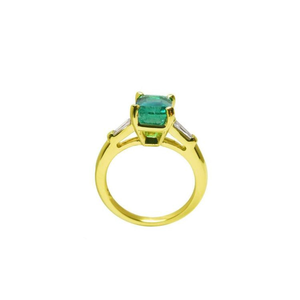 14K gold ring with a rectangular emerald-cut emerald and tapered baguette side diamonds.