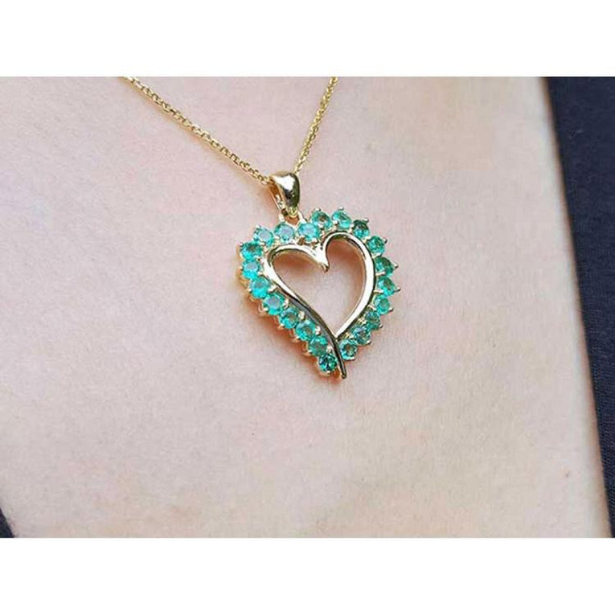14K gold heart pendant necklace with brilliant round Muzo Colombian emeralds.