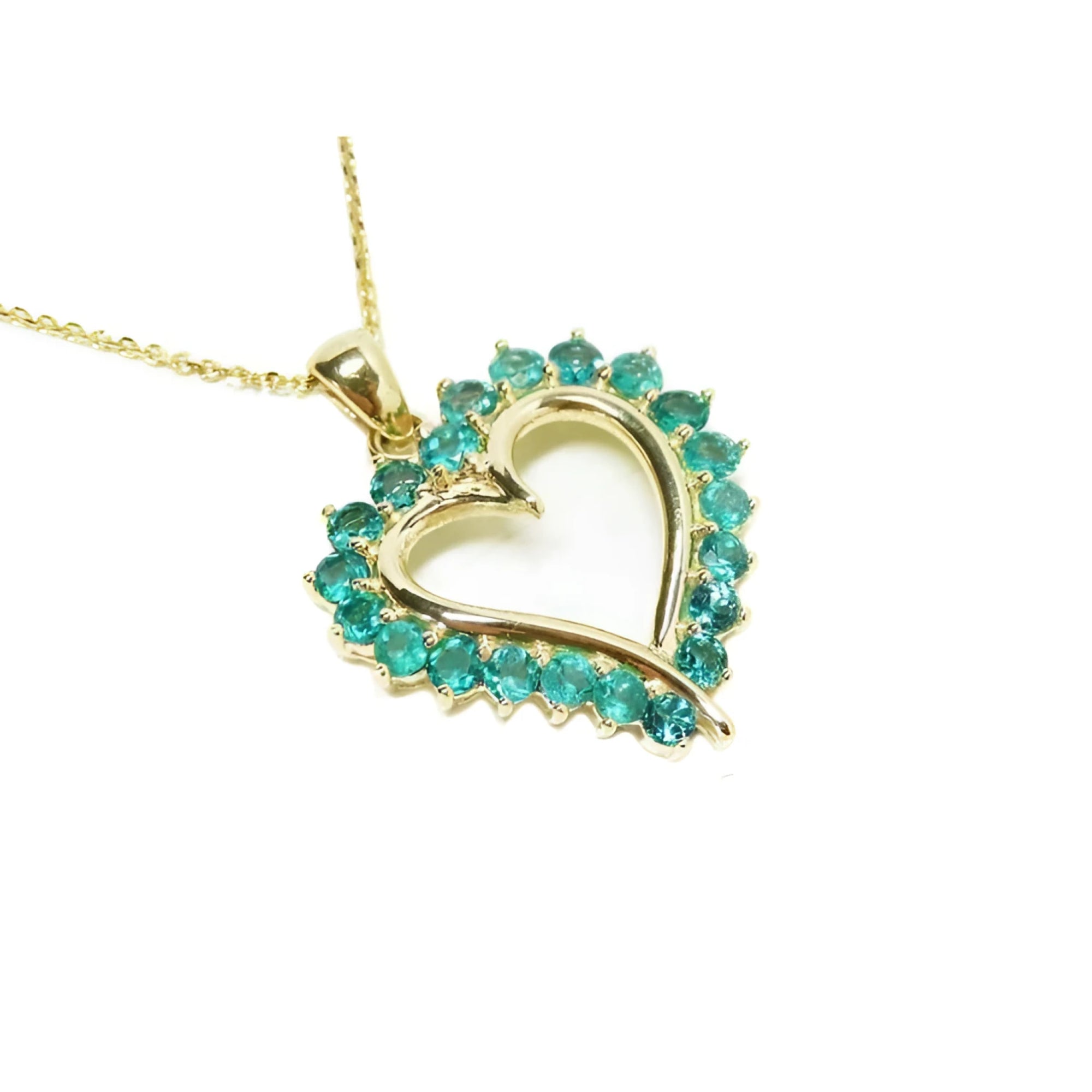 Gold heart-shaped pendant with round cut natural emeralds on a right topside view.