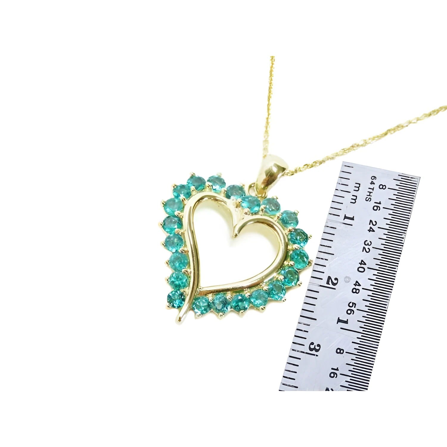 1.42 ct. emerald heart pendant necklace with 14K gold chain, shown with ruler for size.