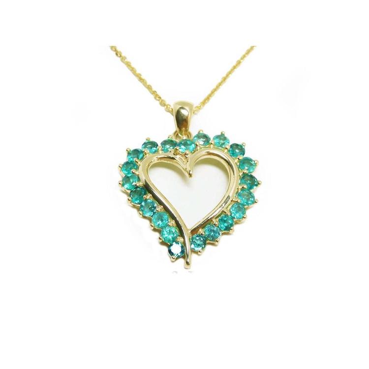 Heart-shaped pendant with emerald stones on a gold chain topside view.