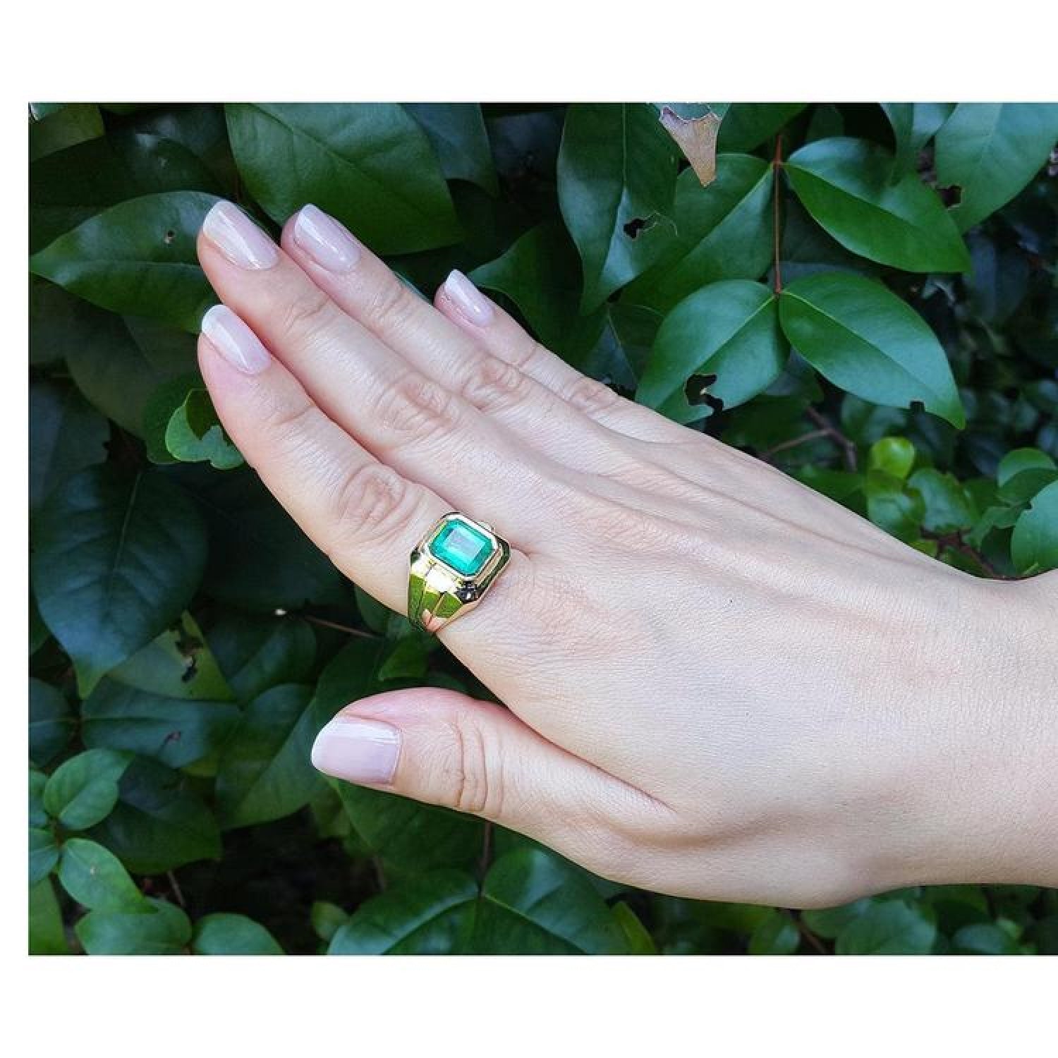 18K yellow gold men's solitaire ring with a square emerald cut Muzo Colombian emerald in a full bezel setting.