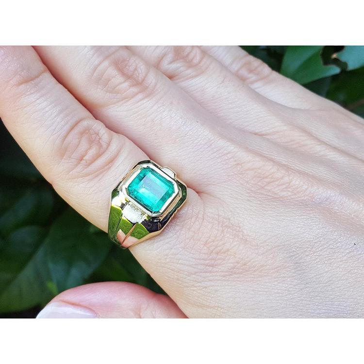 18K yellow gold men's solitaire ring with a square emerald-cut Muzo Colombian emerald in a full bezel setting.