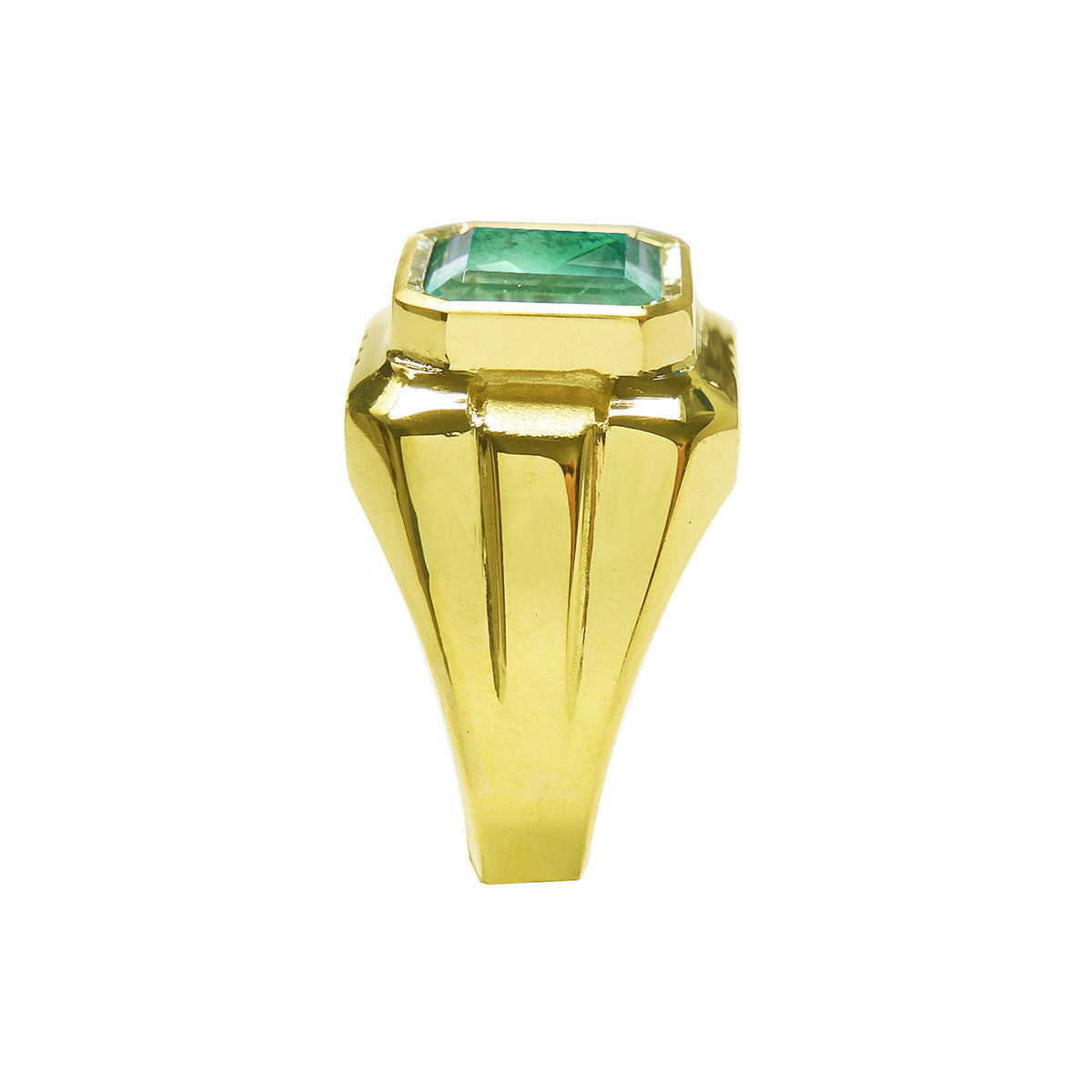 Gold ring for man with a bezel set natural colombian emerald on a white background.