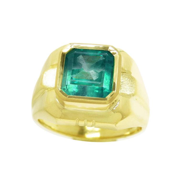 A yellow gold men's ring with a natural square colombian emerald in bezel set displaying the topside view.