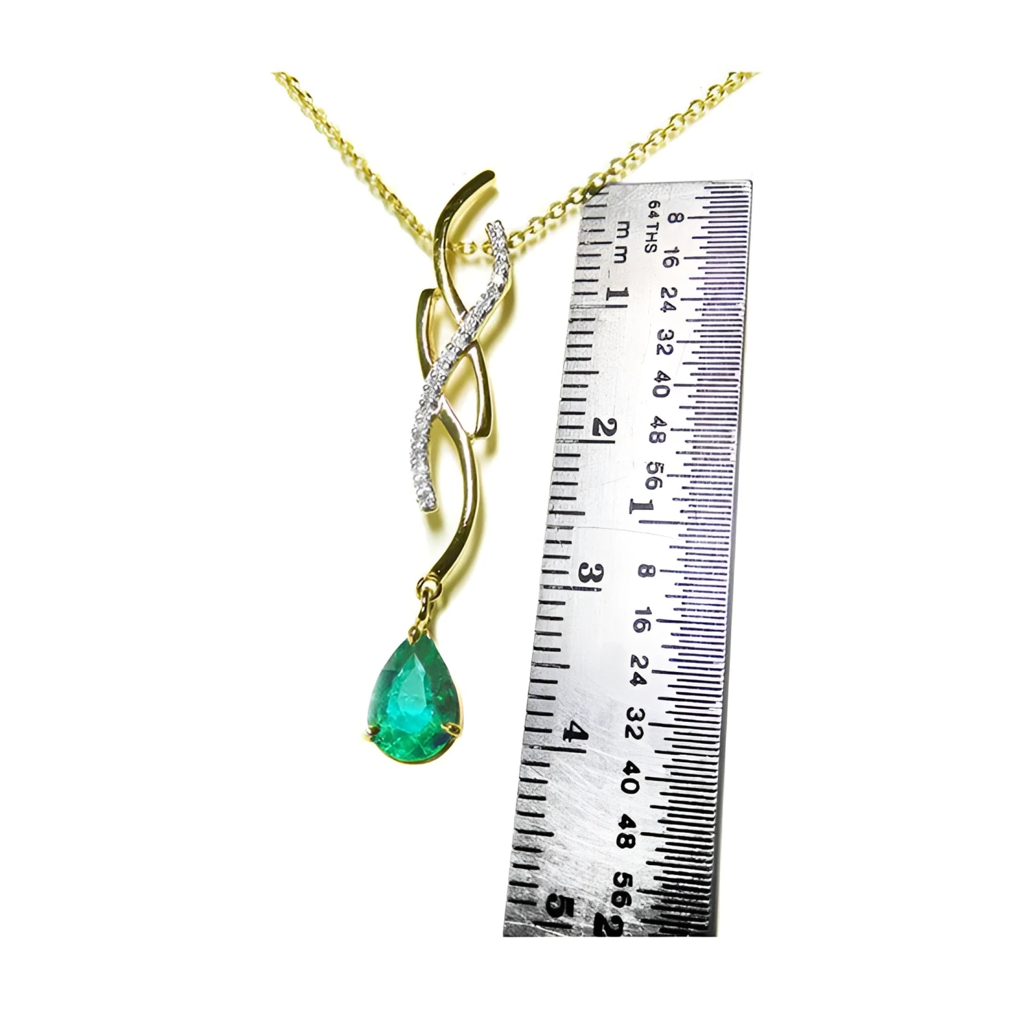 14K yellow gold twisted slider necklace with a pear-shaped emerald pendant and diamond accents, shown with a ruler.