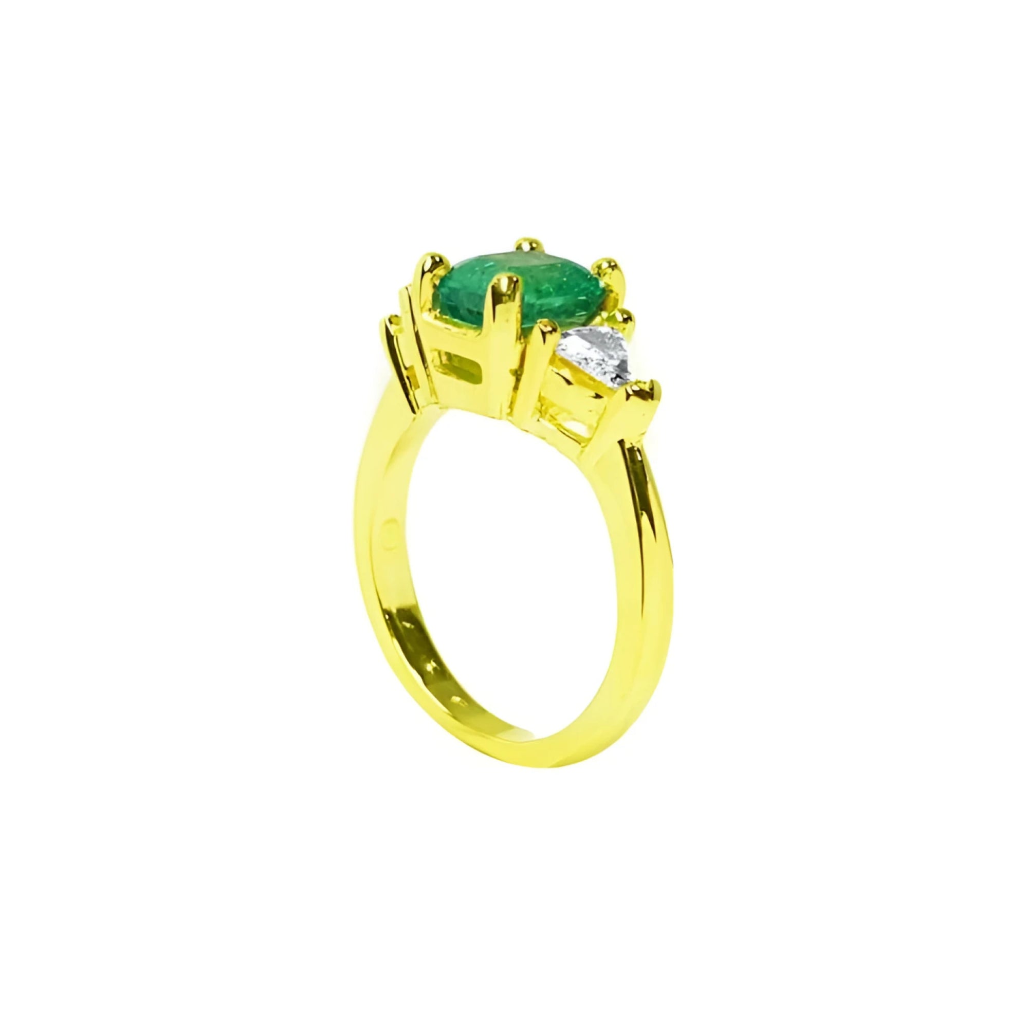 18k gold ring with a 1.51 ct. oval emerald and two trillion-cut side diamonds.