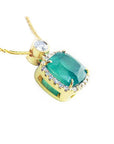 Cushion-cut emerald pendant with diamond halo on an 18K yellow gold chain.