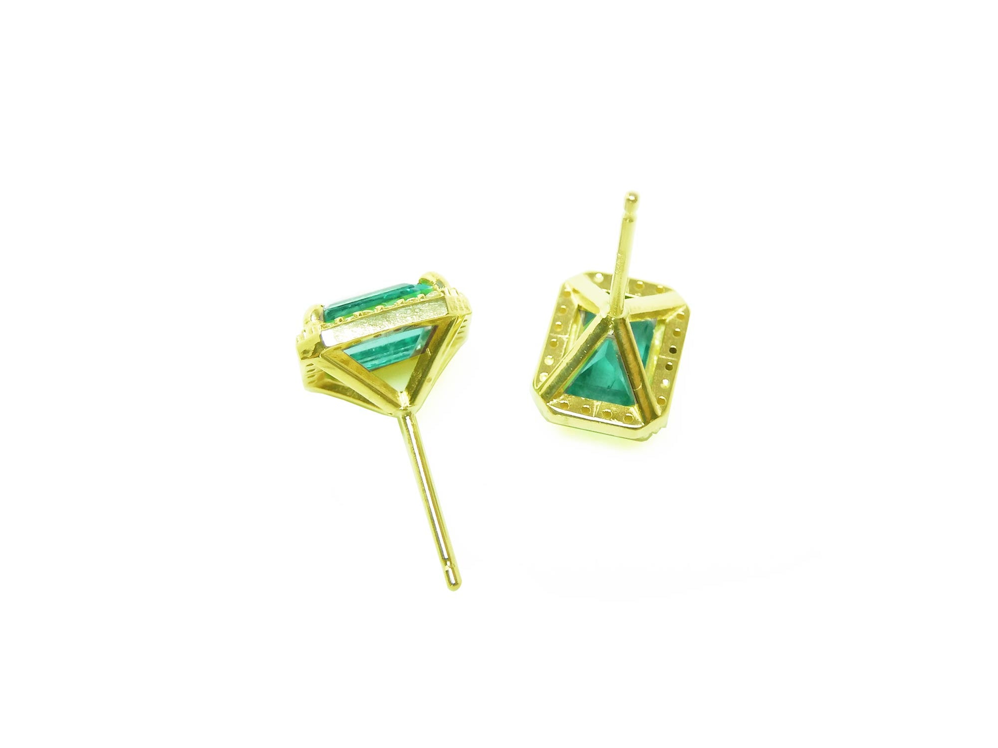 A pair of yellow gold earrings with genuine emeralds upside down for an underside view