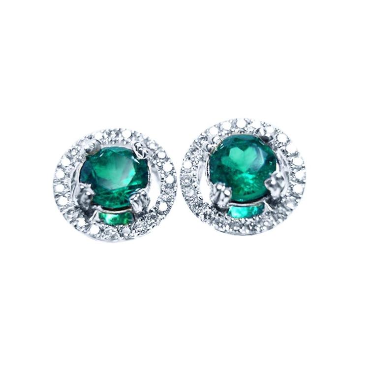 Pair of halo diamond emerald stud earrings, top view on a front position