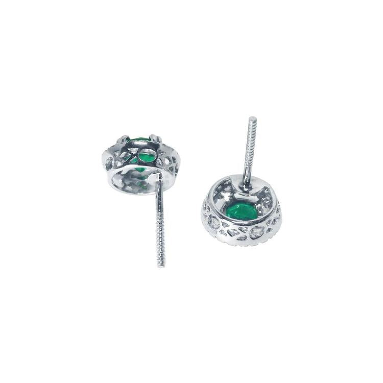 1.06 ct deep bluish-green emerald stud earrings with diamond halo and secure screw backs in 14K white gold.