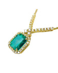 Bluish deep green emerald halo necklace with natural diamonds on 14K yellow gold chain.