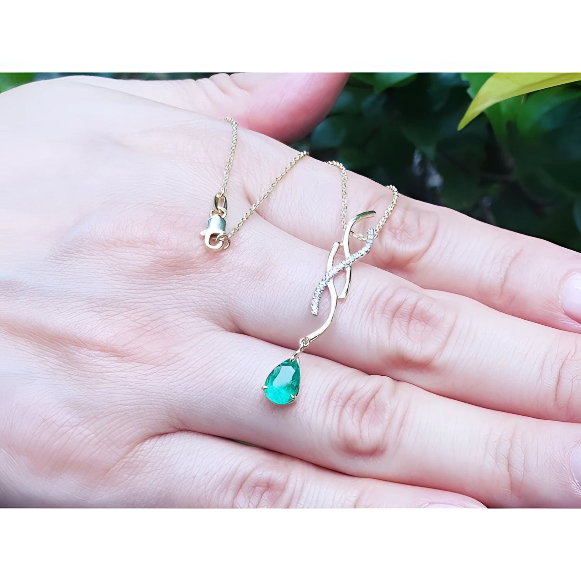 14K yellow gold twisted slider necklace with a medium deep green pear-shaped emerald pendant.