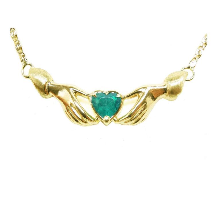 14k yellow gold Claddagh necklace with a heart-shaped emerald gemstone on a white background