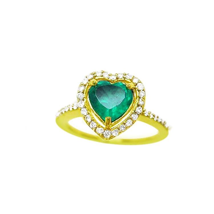 A heart cut emerald engagement ring with a halo diamonds 14k yellow gold.