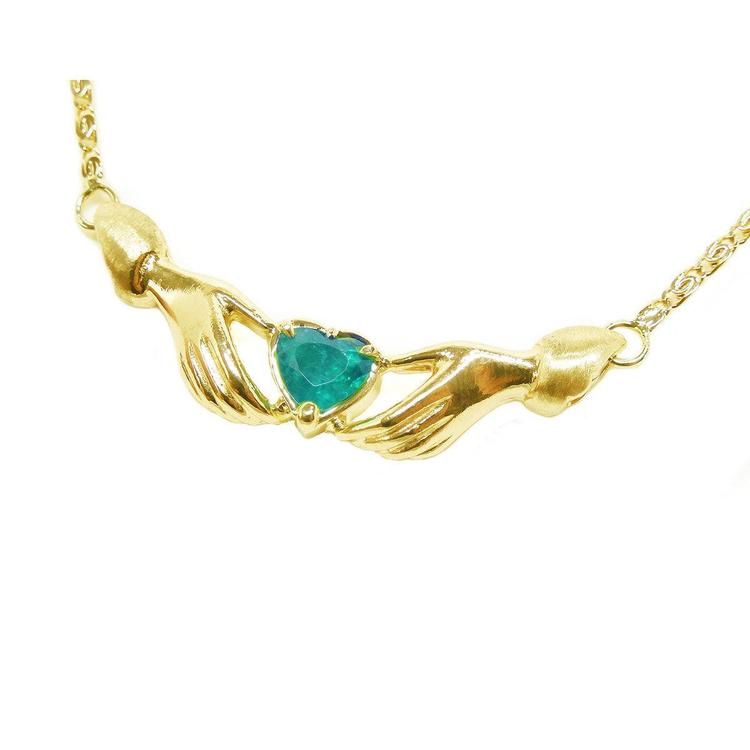 14k yellow gold Claddagh necklace with a heart-shaped green gemstone on a white background