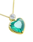Emerald heart shaped pendant with a yellow gold necklace, right side position top plein view